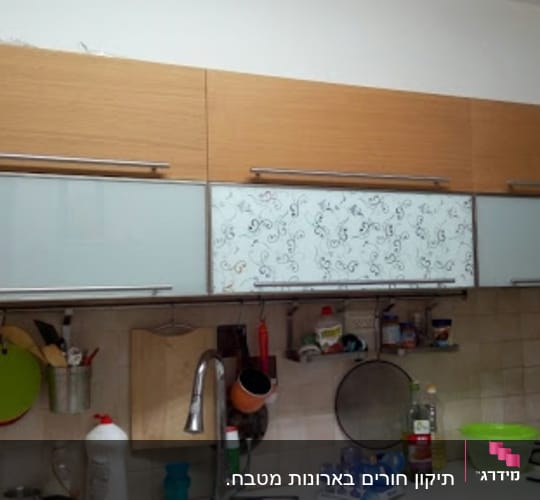kitchen cabinets with utensils and sink